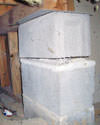 Concrete crawl space support posts in Long Beach that are showing signs of failure as they sink into the earth.