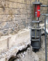 A completed installation of foundation piers lifting a foundation in New Hyde Park