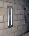 an inside view of foundation wall anchors installed along a basement wall to brace and repair the structure in West Babylon